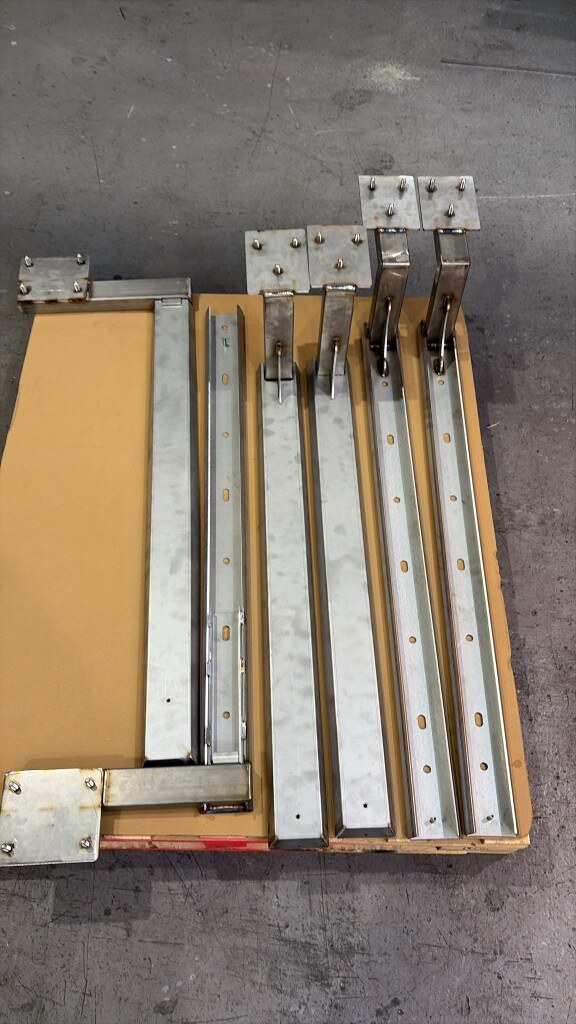 Custom LoadBear awning brackets freshly fabricated in the workshop before finishing