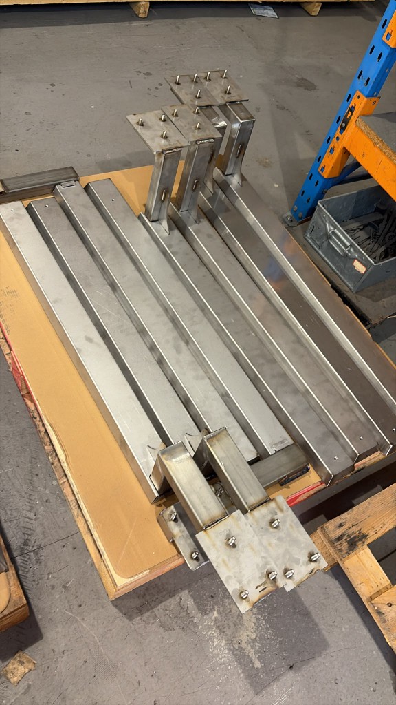 Batch of LoadBear awning brackets on a pallet before powder coating