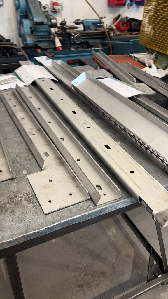 Extreme Gutter Bracket channels and wall plates laid out for inspection
