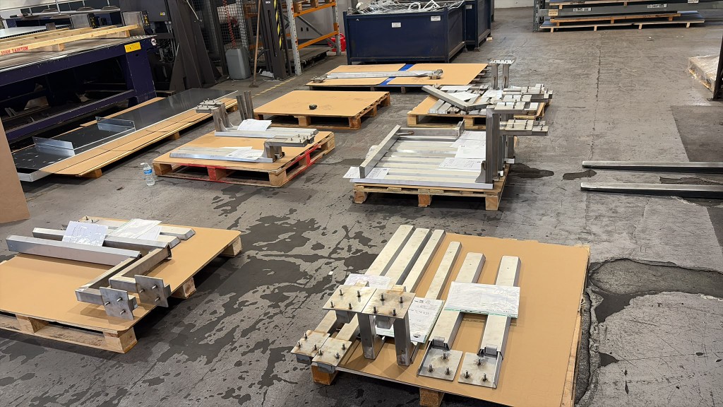 Last July batch of custom LoadBear awning brackets on workshop pallets ready for paint