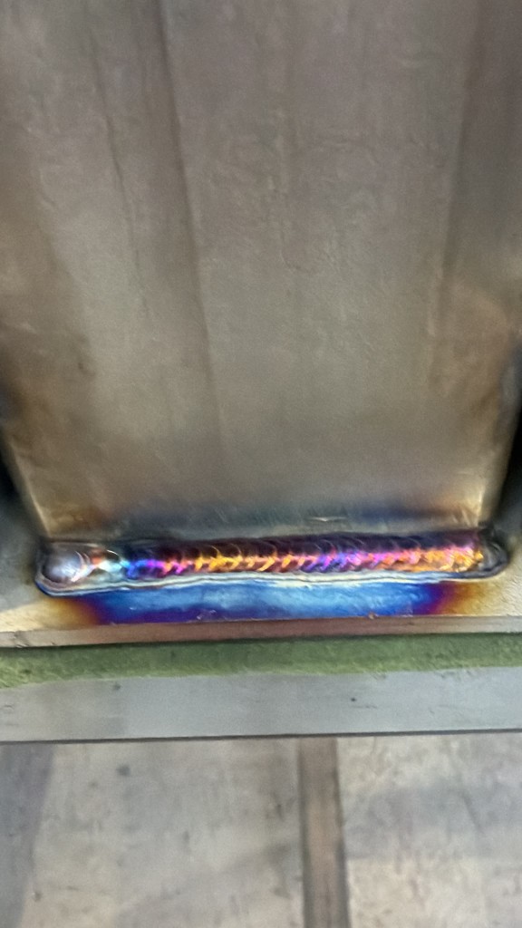 Rainbow heat-tint TIG weld close-up on LoadBear Extreme Gutter Bracket stainless