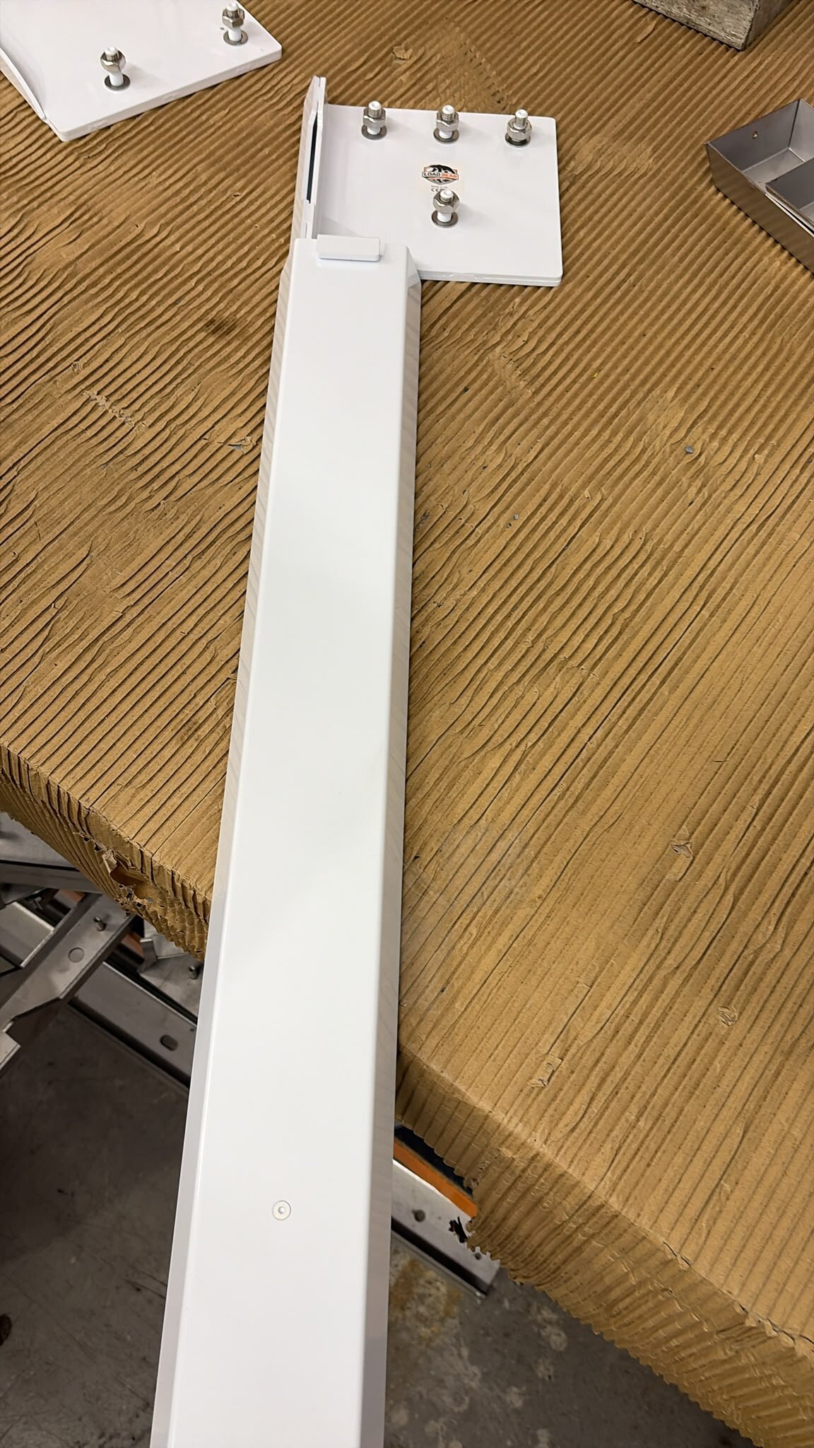 White LoadBear mounting plate with studs, washers and logo sticker