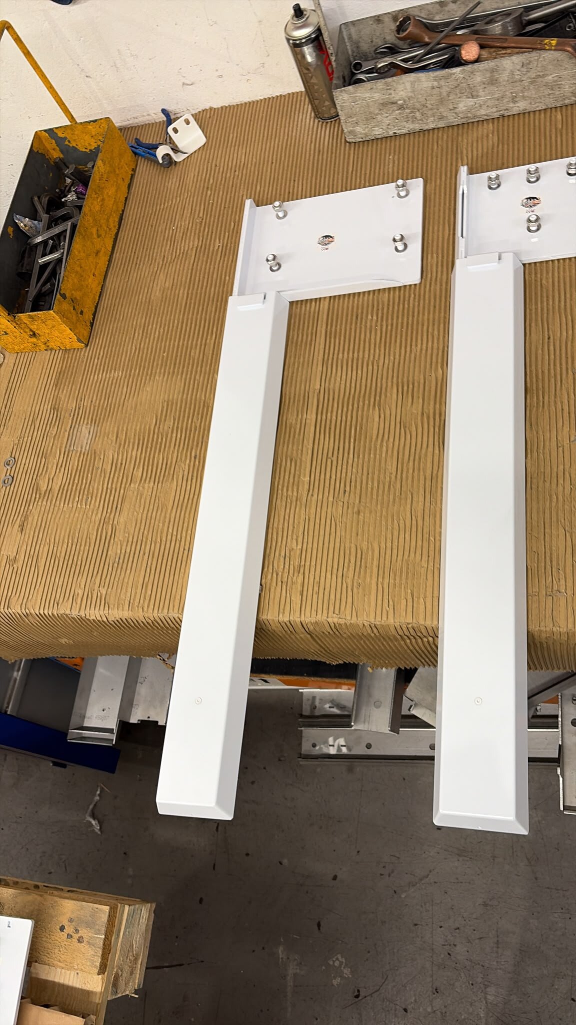 Pair of white LoadBear custom uprights on the workshop bench