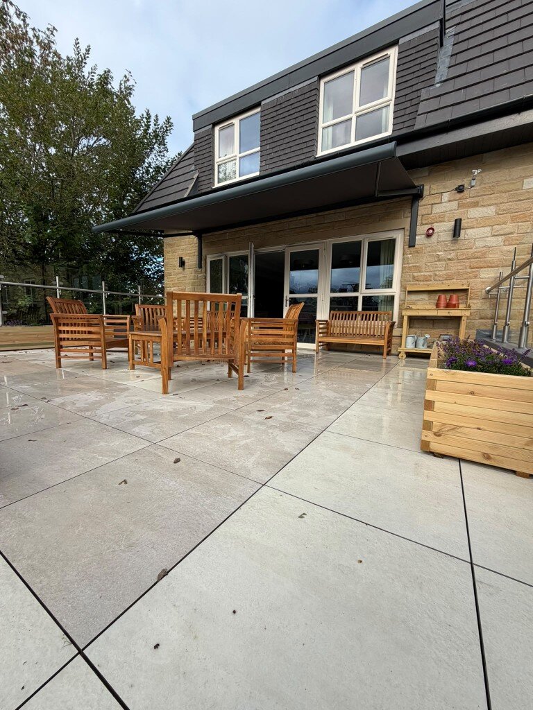 Extended black patio awning on custom-length LoadBear standard spreaders