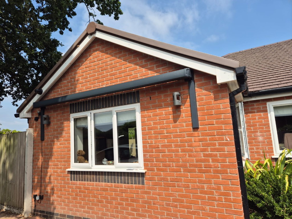 Anthracite stainless steel awning brackets holding a cassette awning on a UK home