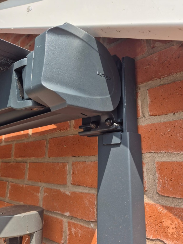 Close-up of an anthracite awning cassette attached to a LoadBear wall bracket