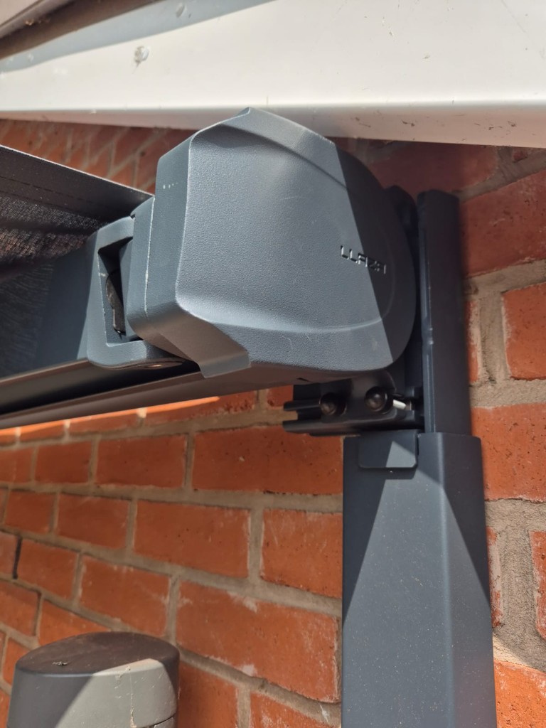 Detailed view of the colour-matched LoadBear bracket connection beneath an awning cassette