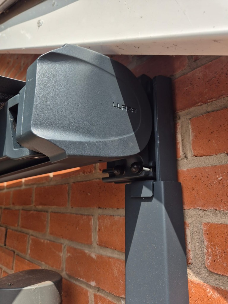 Close-up of adjustable awning mounting hardware secured to an anthracite LoadBear bracket