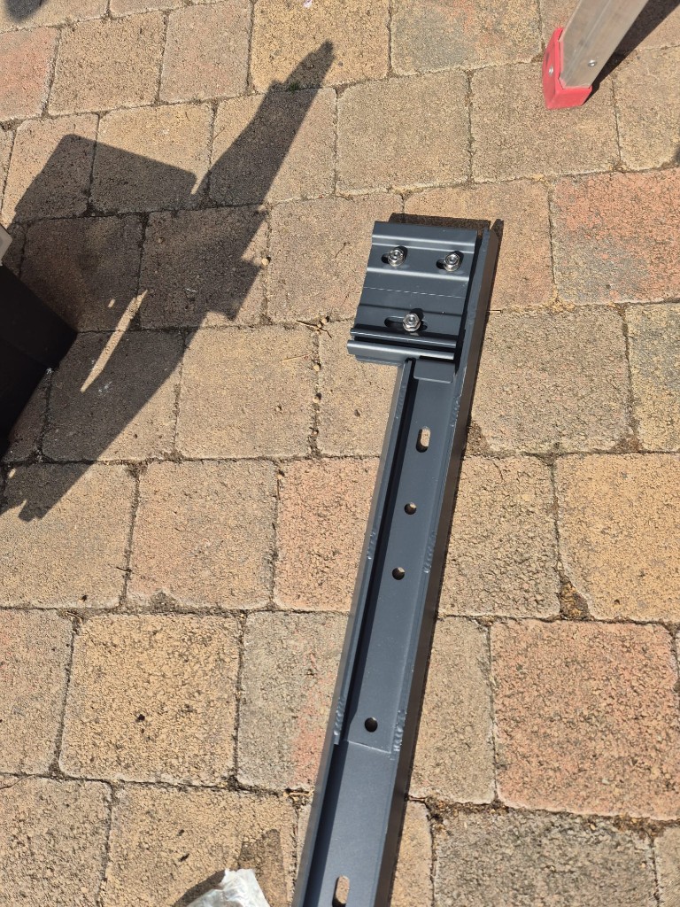 Close view of the LoadBear awning bracket mounting plate and stainless adjustment bolts