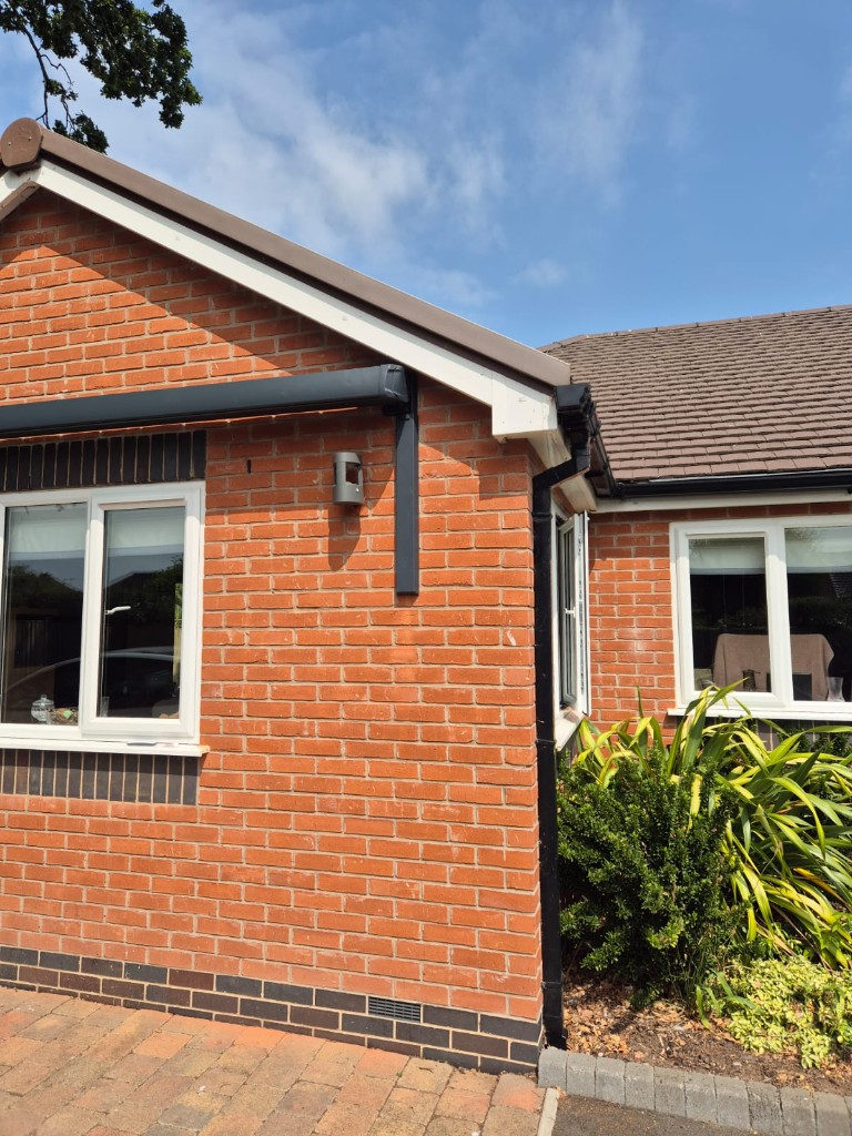 Right-hand anthracite LoadBear awning bracket fitted neatly beside an exterior wall light