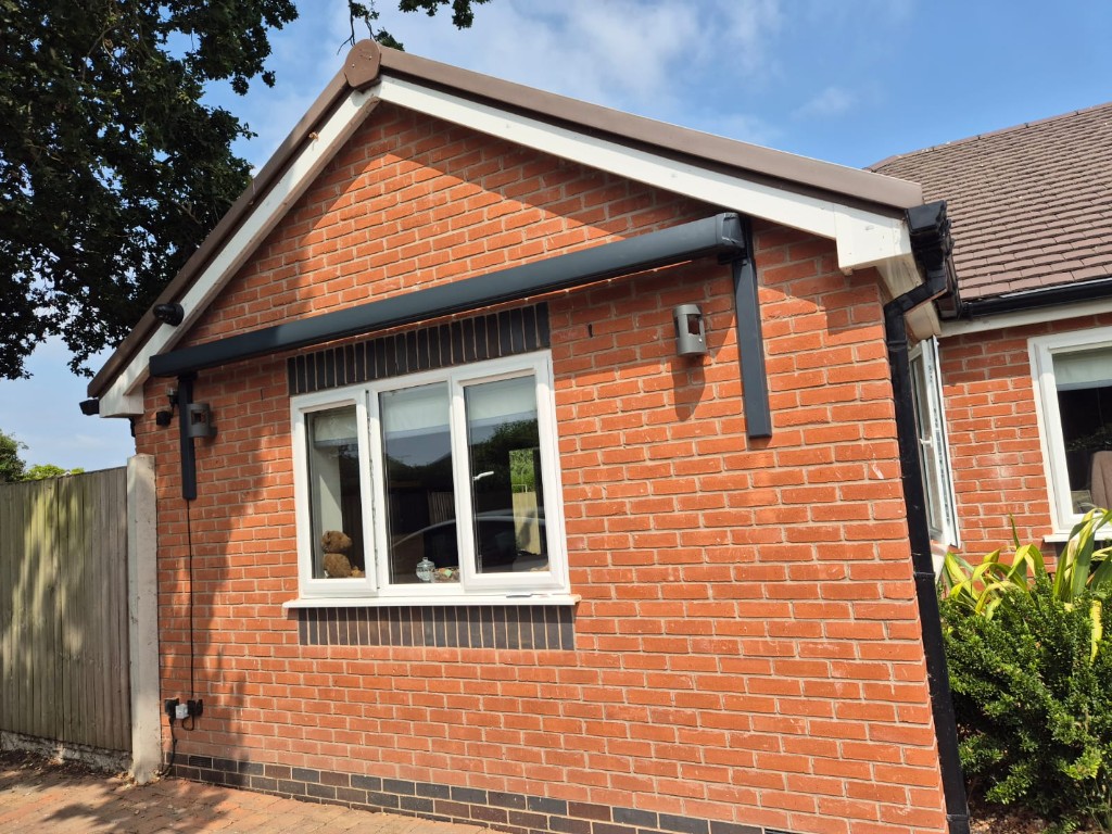 Full view of an anthracite awning and LoadBear brackets fitted around a bungalow window