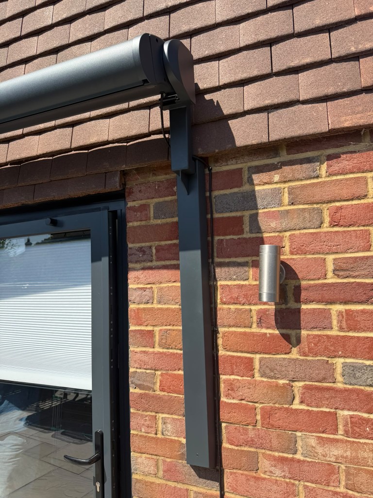 Anthracite LoadBear upright and BASE cassette fitted to red brick under a tiled roof