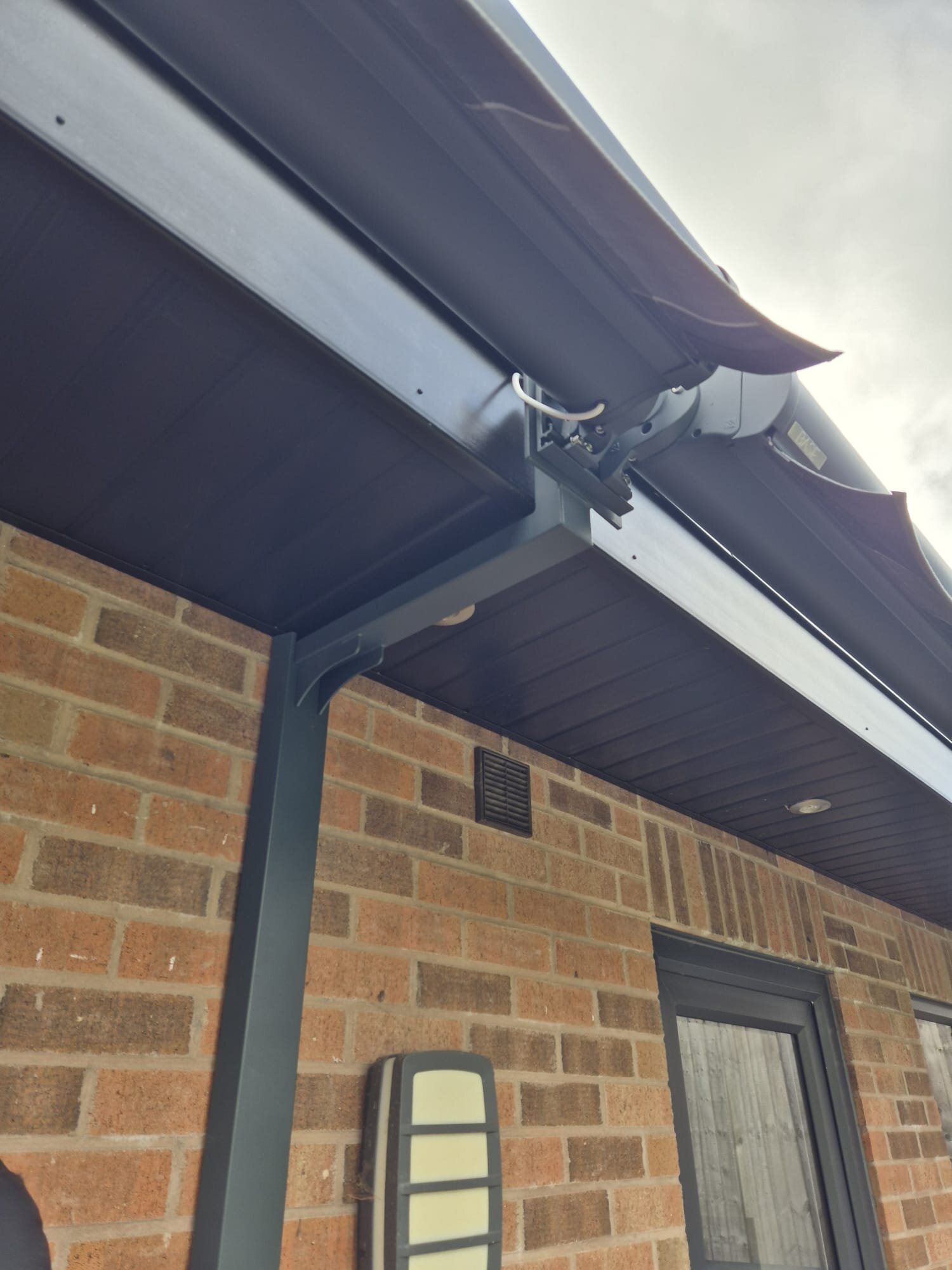 LoadBear gutter bracket clearing black gutter and fascia on a brick elevation