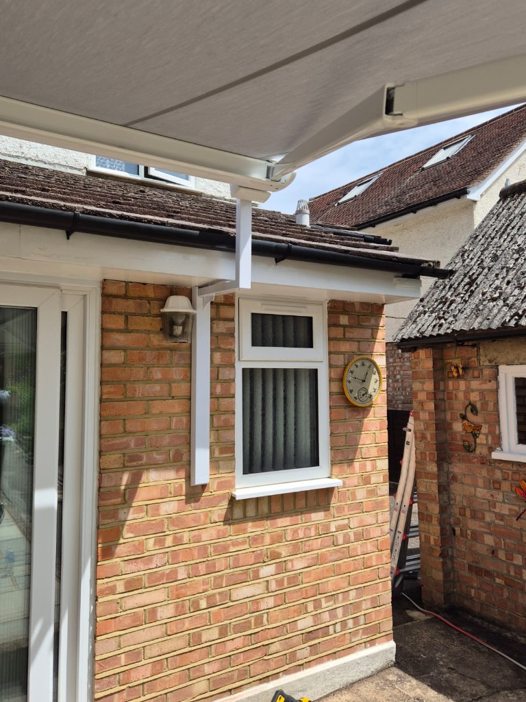 Profile view of LoadBear gutter bracket and awning cassette above a patio door